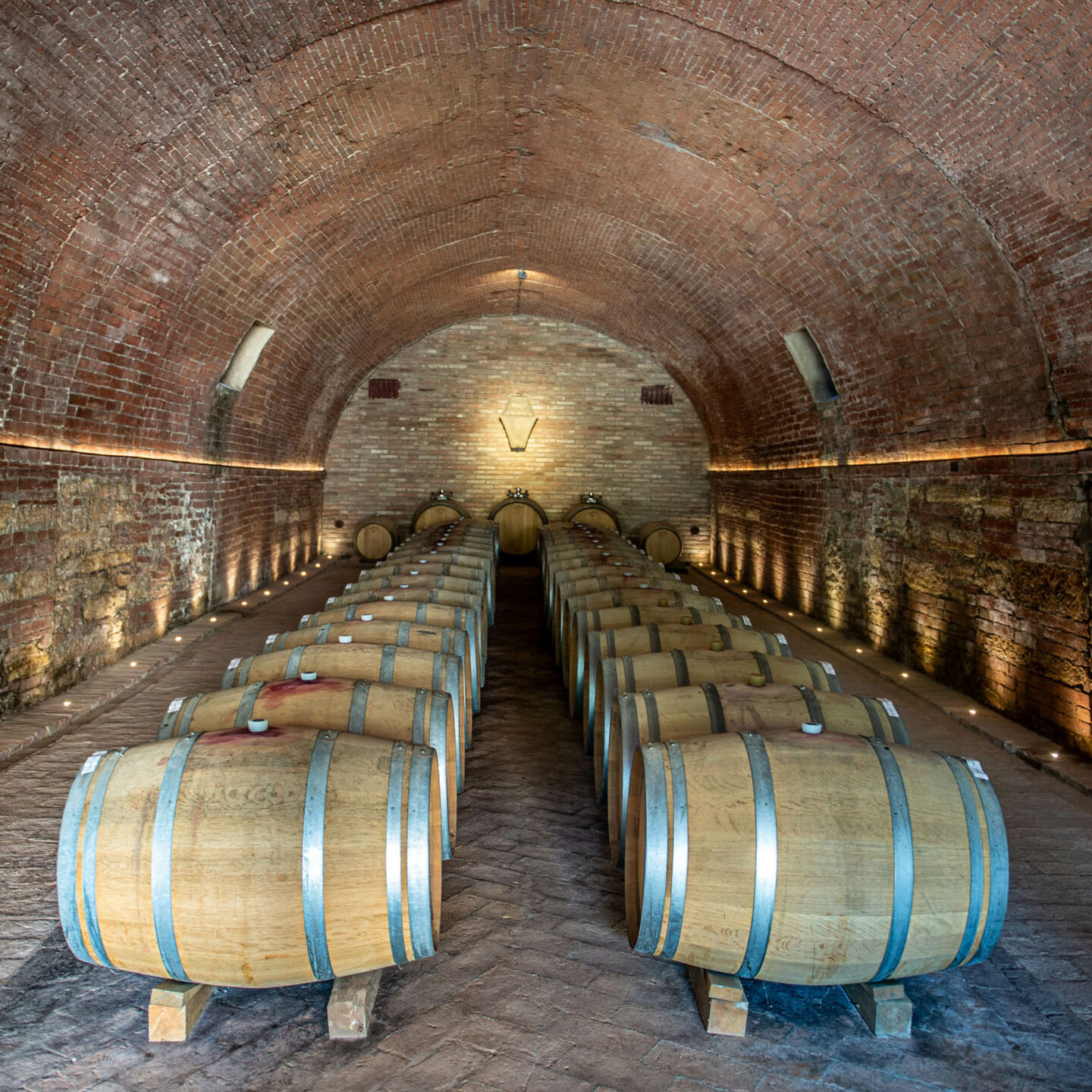 Underground cellar of Cantina Villa Cosmiana with wine barrels