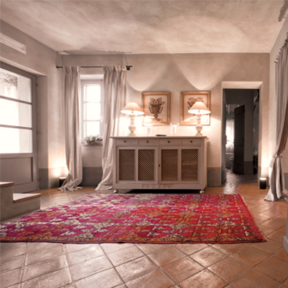 Cozy living room with red patterned rug, neutral walls, and classic furniture.